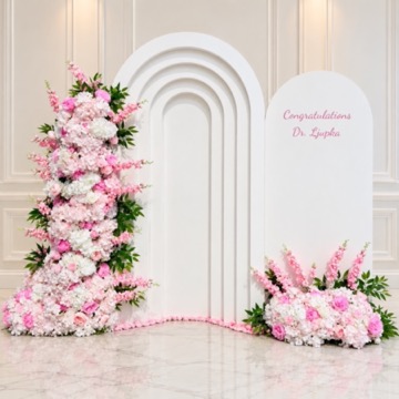 White layered arches with pink faux floral arrangements